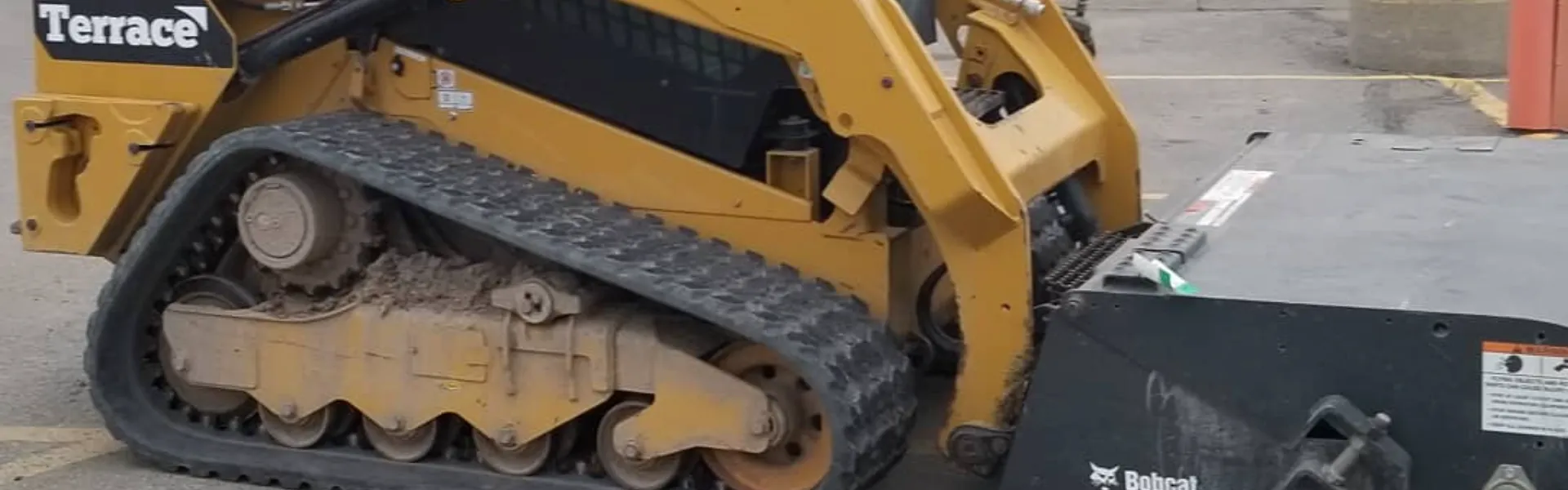 Track loader working on a commercial property